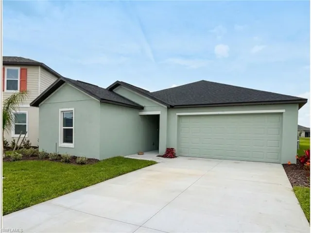 Contemporary front elevation featuring a two-car garage, concrete driveway, and professionally landscaped yard.