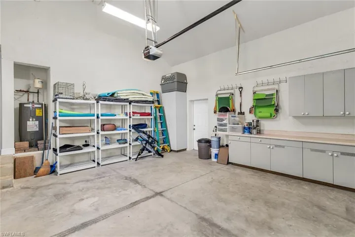 Garage with water heater and a garage door opener