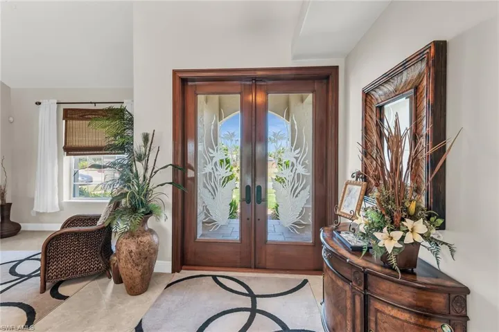 Entrance foyer with french doors and baseboards
