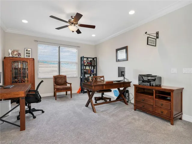 Spacious upstairs loft featuring light gray carpeting, neutral wall color, crown molding, recessed lighting, and a ceiling fan with light fixture