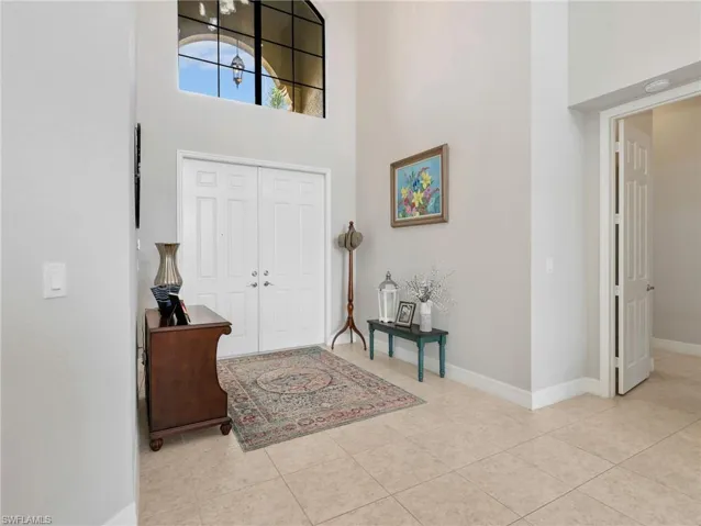 Double entry doors with transom window and high ceilings