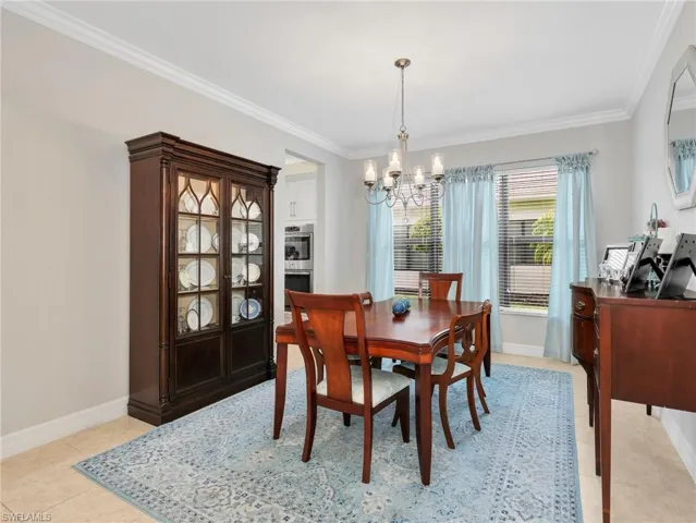 Dining area featuring crown molding, neutral wall tones, and recessed lighting
