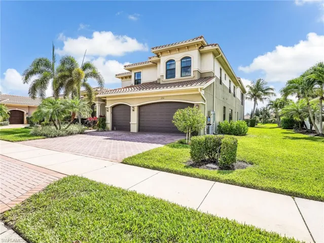 Mediterranean-style residence featuring a tile roof and stucco exterior