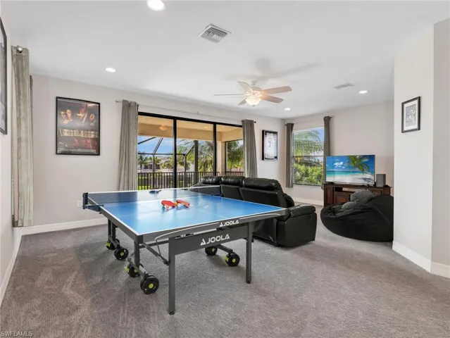 Carpeted recreational room with recessed lighting and a ceiling fan