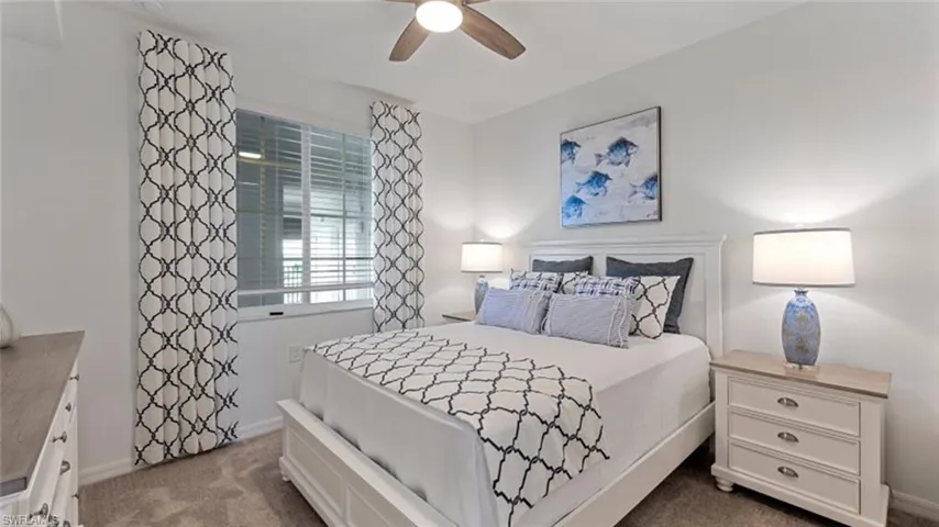 Bedroom featuring dark carpet and ceiling fan