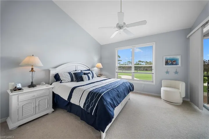 Bedroom with ceiling fan, light carpet, and lofted ceiling
