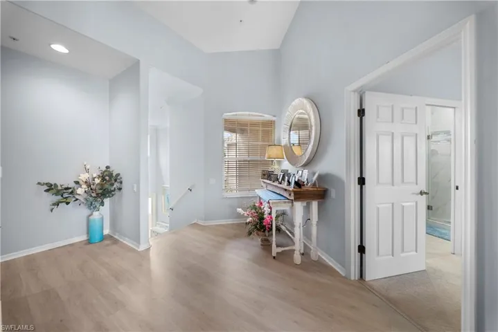 Hall featuring light wood finished floors and an upstairs landing