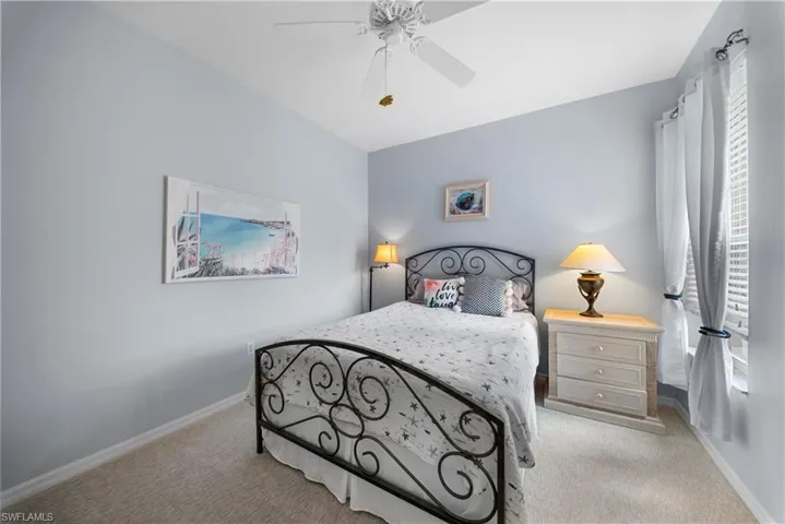 Bedroom featuring a ceiling fan and light carpet