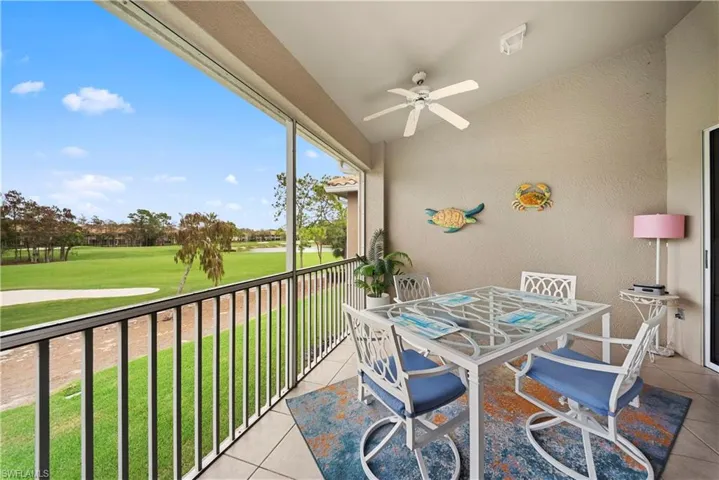 Sunroom / solarium featuring lofted ceiling, outdoor dining space, view of golf course, and ceiling fan