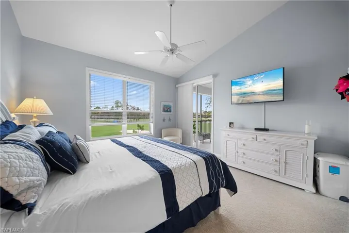 Bedroom featuring lofted ceiling, carpet floors, access to outside, and ceiling fan