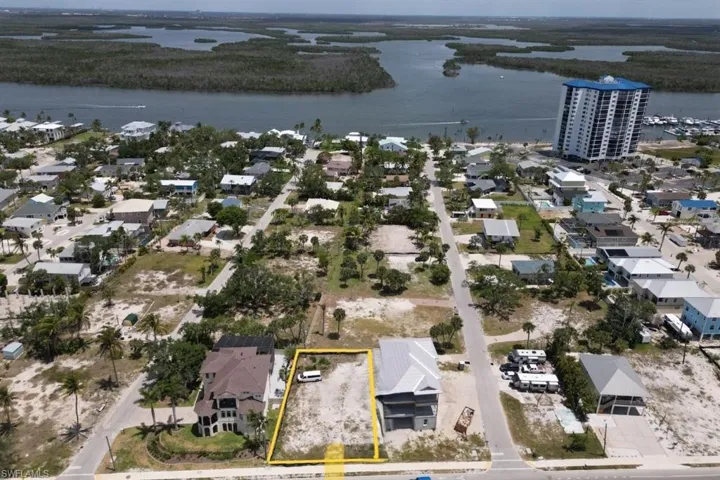 Aerial perspective looking East to intercoastal body of water and property parcel outlined