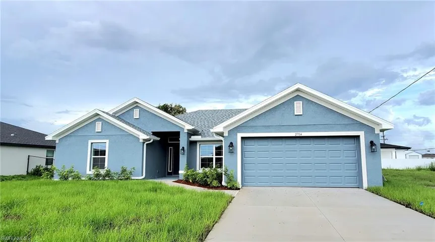 View of front facade with a garage and a front yard