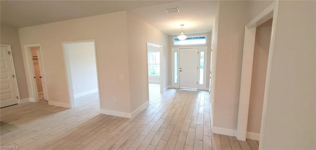 Foyer entrance featuring light hardwood / wood-style floors