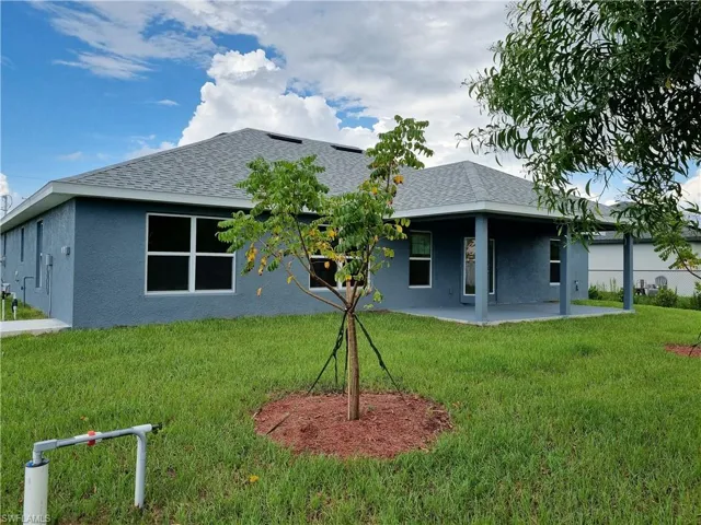 Back of house featuring a patio area and a yard