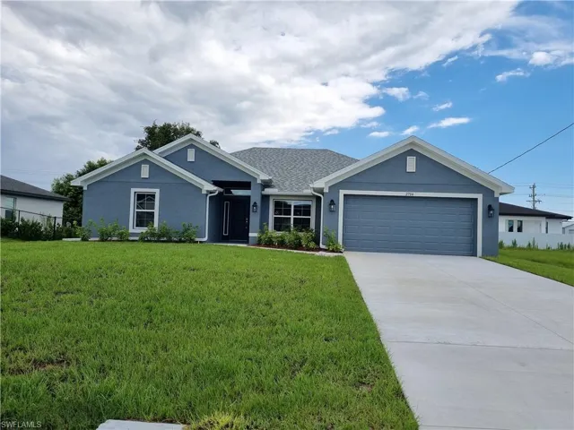 View of front facade with a front lawn and a garage