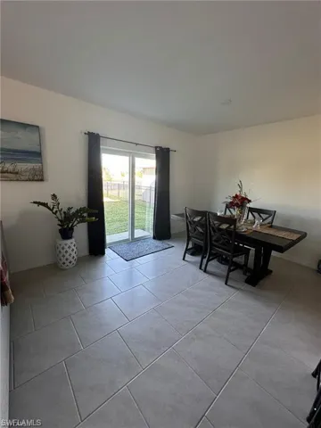 Dining area with light tile patterned floors