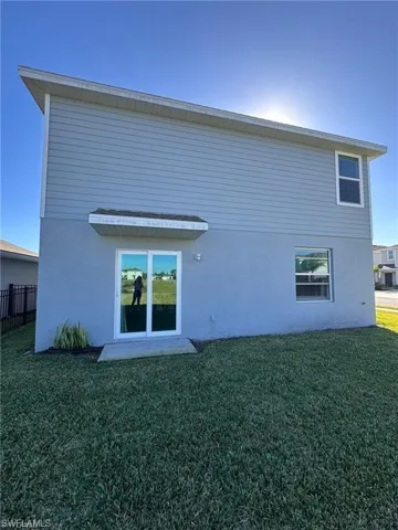 Rear view of house featuring stucco siding
