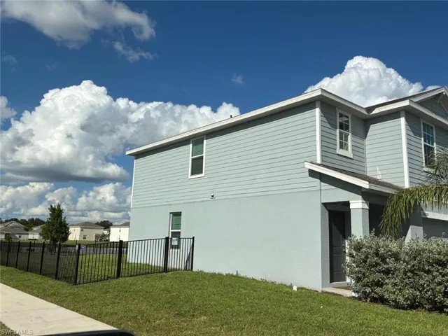 View of side of home featuring stucco siding
