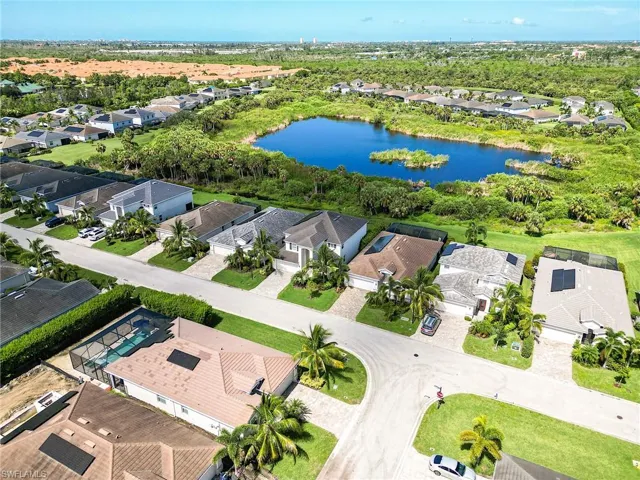 Birds eye view of property with a water view