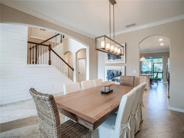 Tiled dining room with crown molding