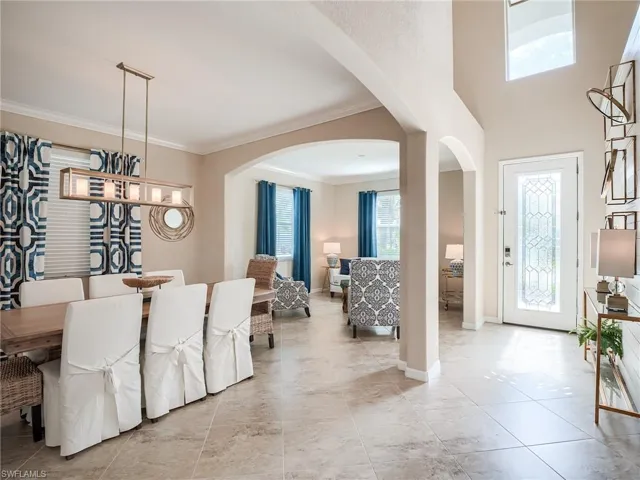 Tiled dining space with crown molding
