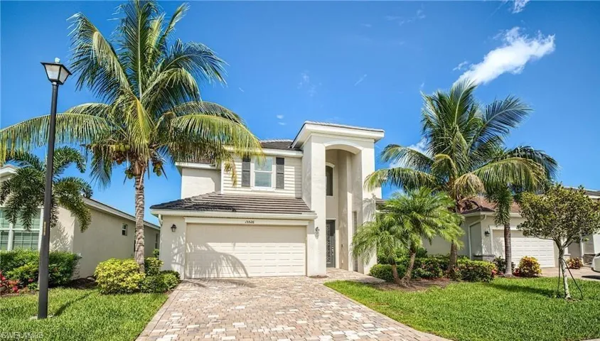 View of front of property featuring a garage and a front yard