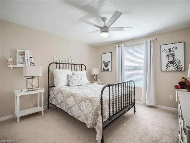 Bedroom with light colored carpet and ceiling fan