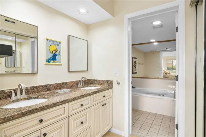 new double vanity with double sinks and stone counter top - walk in closet to the right