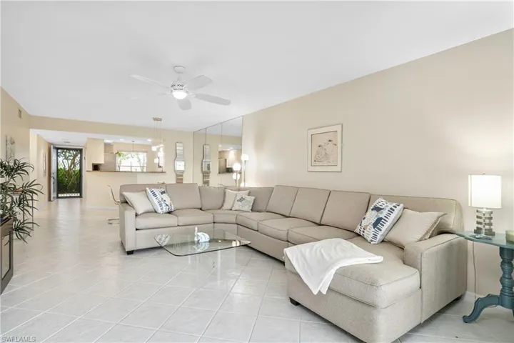 with dining area looking into kitchen - the light colors make this a bright and sunny condo