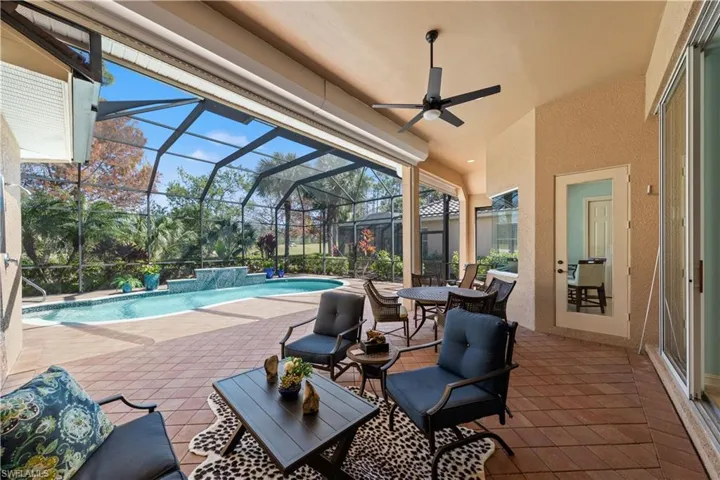 View of patio with an outdoor pool, a sunroom, a ceiling fan, glass enclosure, and outdoor lounge area