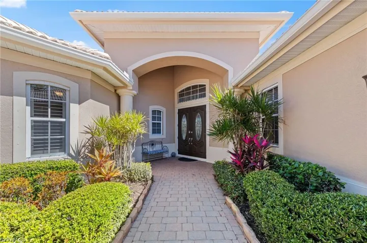 Entrance to property with stucco siding