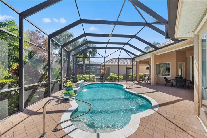 Outdoor pool featuring outdoor dining area, a patio area, a sunroom, and a lanai