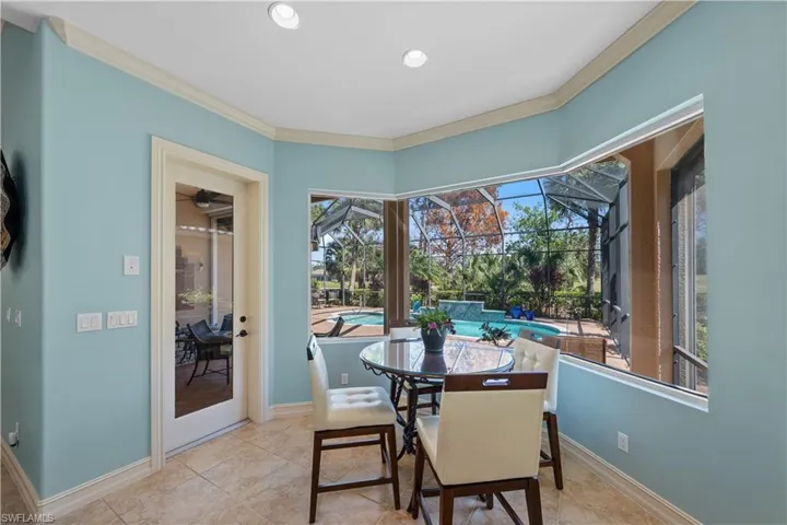 Dining space featuring a sunroom and crown molding