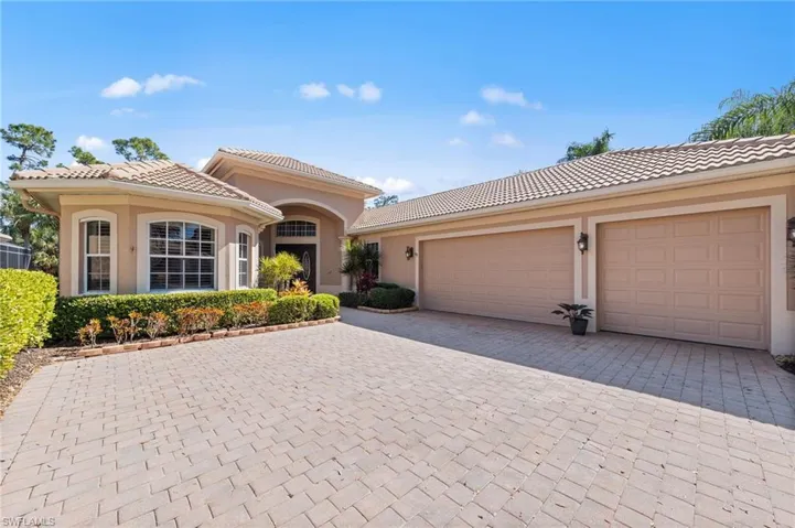 Mediterranean / spanish house with driveway, stucco siding, a tile roof, and an attached garage