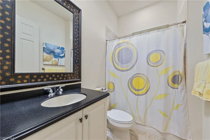 Bathroom with vanity and shower / bath combo with shower curtain