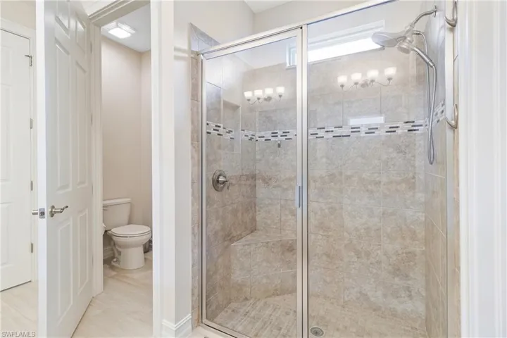 Bathroom featuring toilet and an enclosed shower
