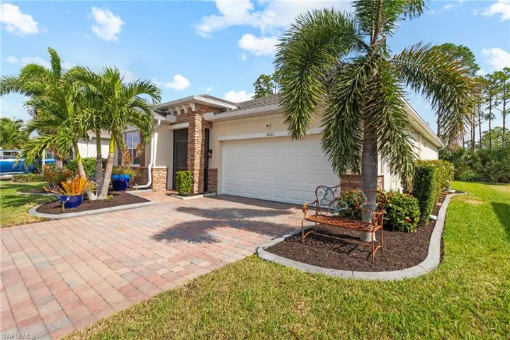 View of front of home with a front lawn and a garage