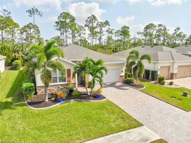 View of front of home featuring a front yard and a garage
