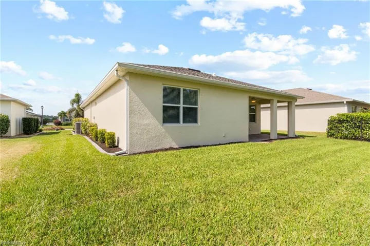 Back of property featuring a yard and a patio
