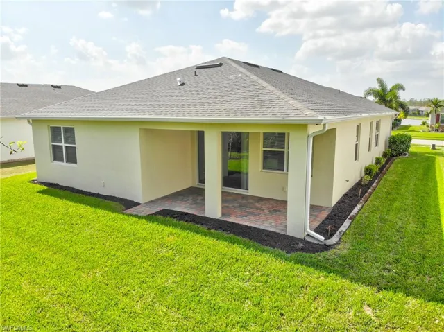 Rear view of property featuring a patio and a yard