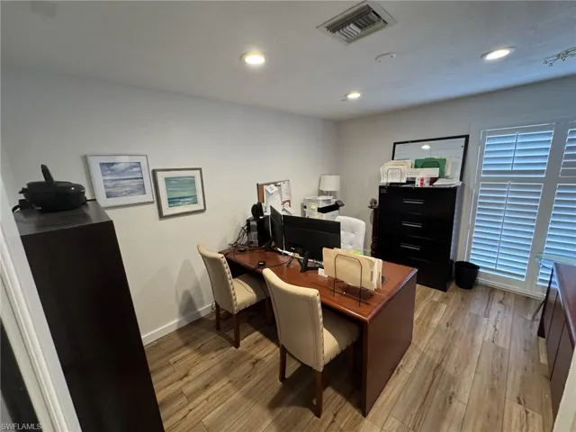 Office area with light hardwood / wood-style flooring