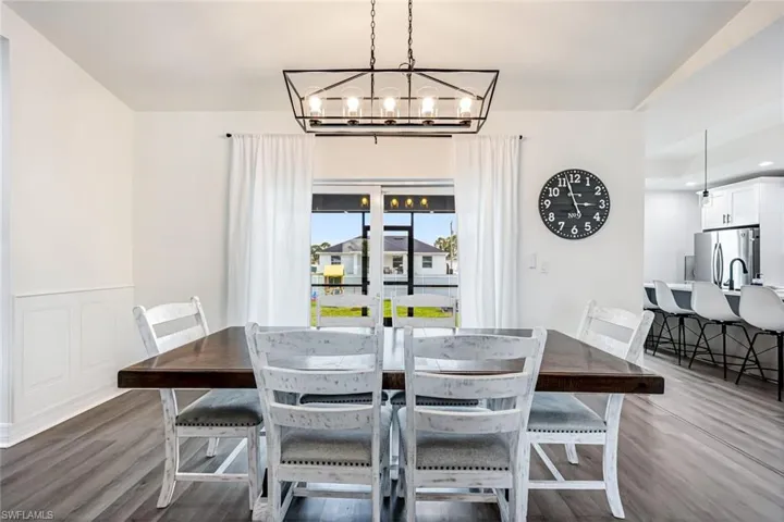 Dining room featuring light wood-type flooring and a chandelier