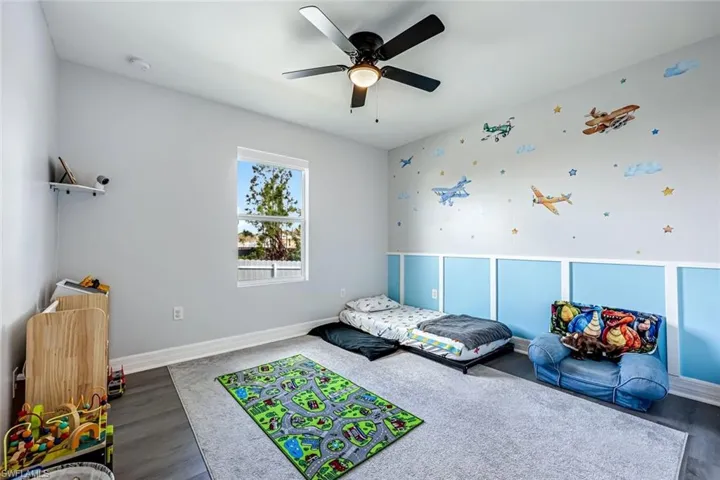 Bedroom featuring ceiling fan and dark wood-style floors