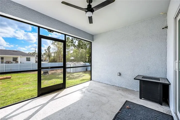Unfurnished sunroom with a ceiling fan