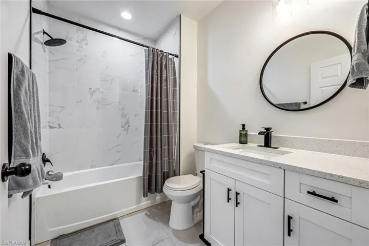 Full bathroom with vanity and shower / tub combo