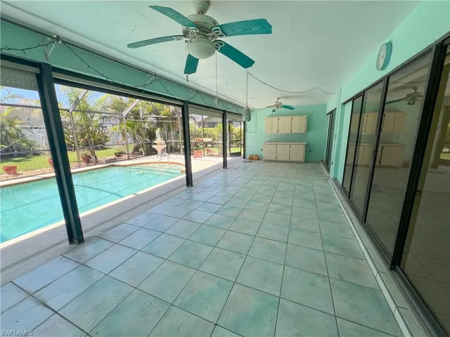 Swimming pool with a ceiling fan, a patio area, and a lanai