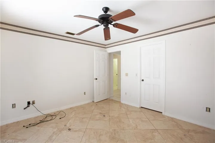 Unfurnished bedroom featuring baseboards and a ceiling fan