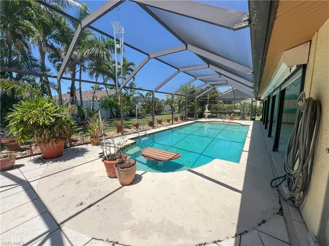 Swimming pool with a patio area and glass enclosure