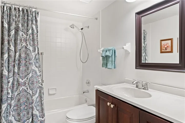 Full bathroom featuring shower / bath combo, vanity, and toilet