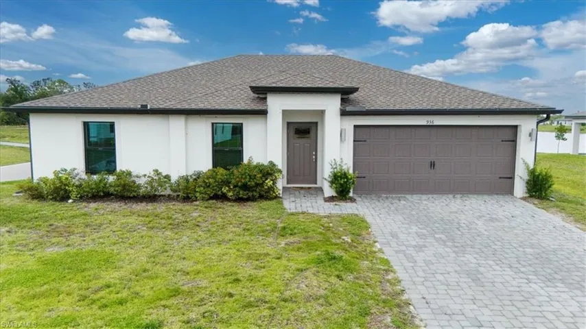 Contemporary single-story residence with a light stucco exterior and a dark shingle roof